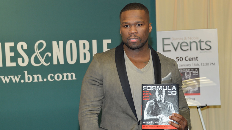 50 Cent holding his book