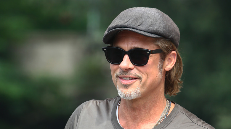 Brad Pitt in cap and glasses 