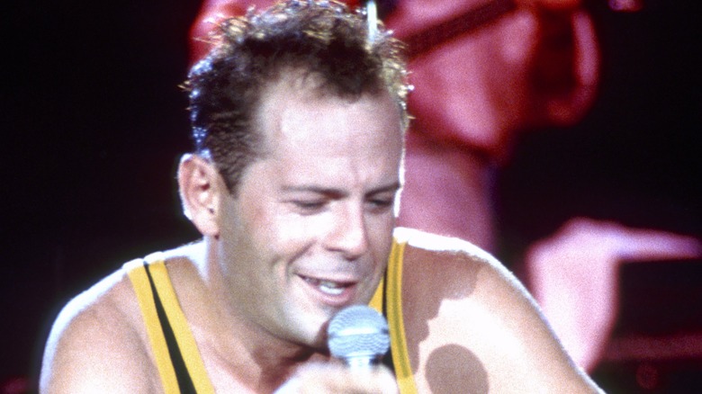 Bruce Willis singing onstage