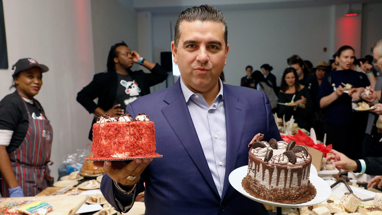 Buddy Valastro posing with cakes