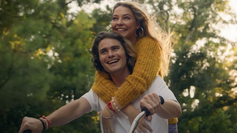 Chase Stokes, Madelyn Cline on a bicycle