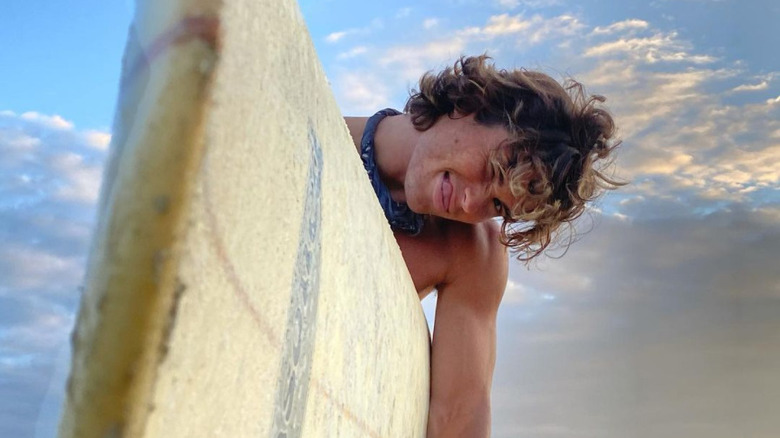 Chase Stokes with his surfboard