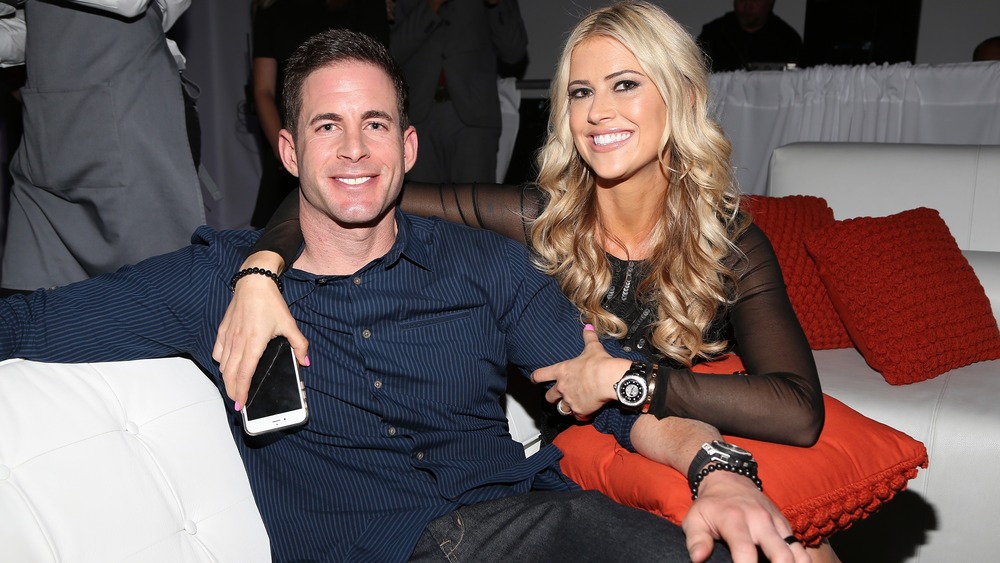 Christina Anstead and Tarek El Moussa sitting on a couch