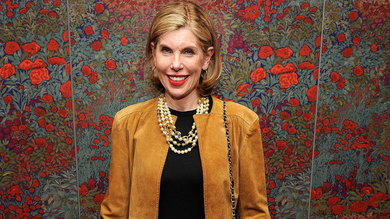 Christine Baranski smiling by flowered wall