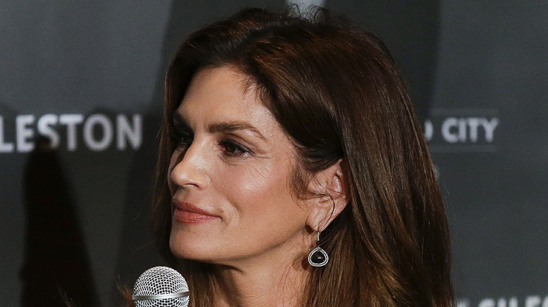 Cindy Crawford with a microphone