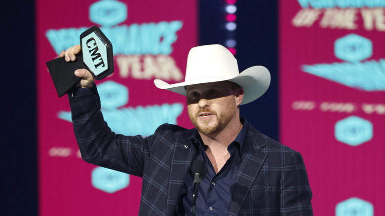 Cody Johnson holding CMT Music Award