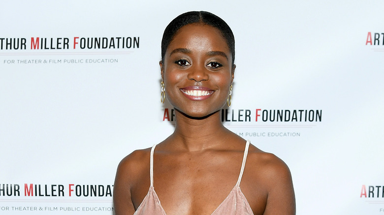 Denée Benton smiling in pink