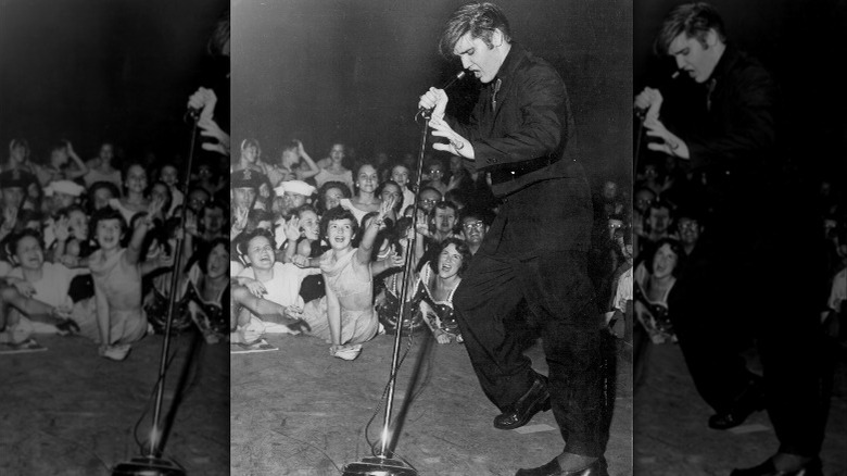 Elvis Presley singing and dancing on stage