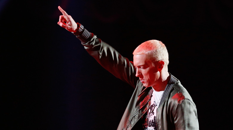 Eminem onstage with hand up