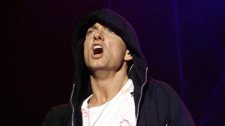 Eminem performing, wearing a hoodie