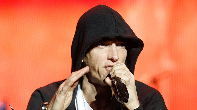 Eminem performing with hand up