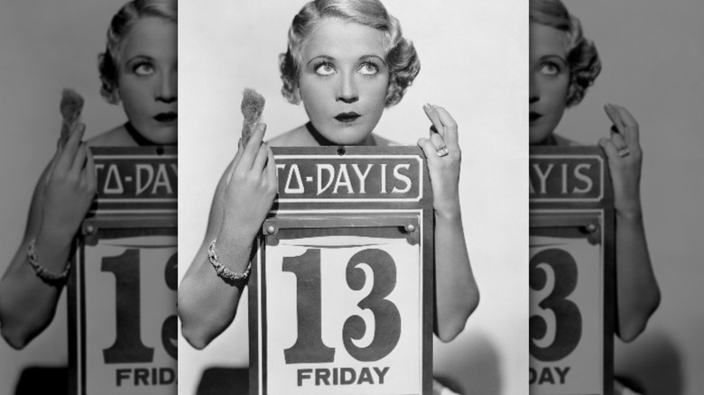 Woman holding a Friday the 13th sign