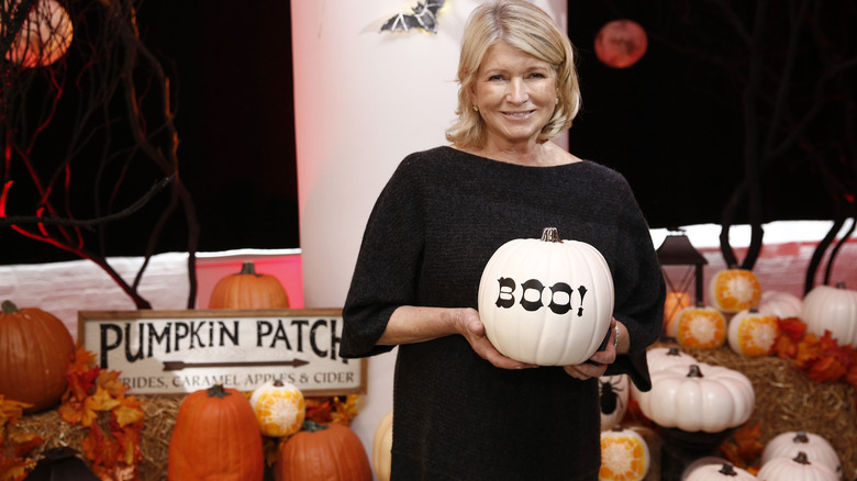 Martha Stewart holding a pumpkin