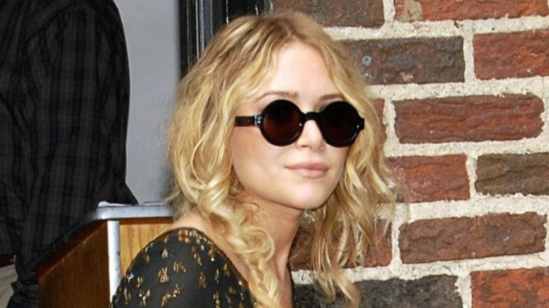 Mary-Kate Olsen smiling in sunglasses