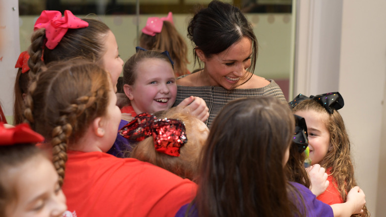 Meghan Markle smiling with children