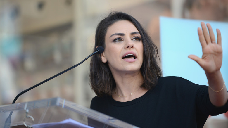 Mila Kunis giving a speech