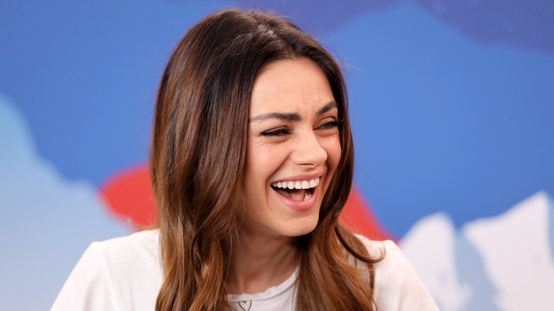 Mila Kunis laughing