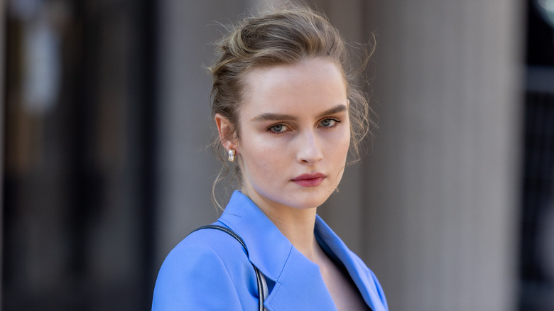 Olivia DeJonge in a blue suit