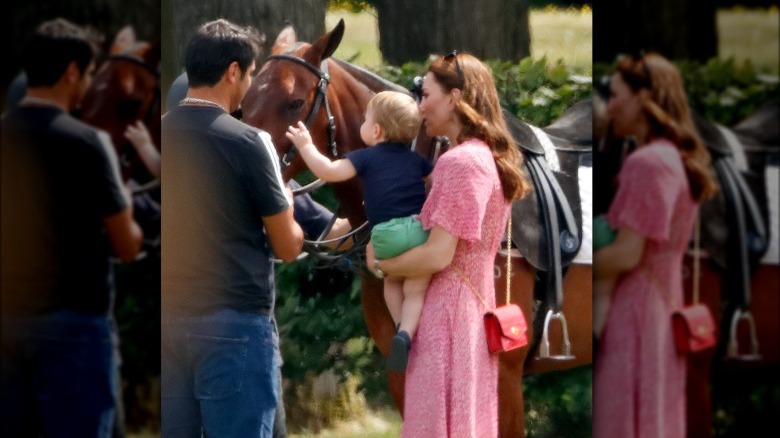 Prince Louis pets a horse