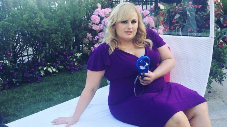 Rebel Wilson sitting outside