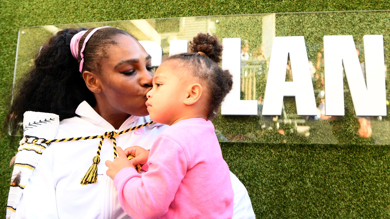 Serena Williams kissing her daughter's cheek