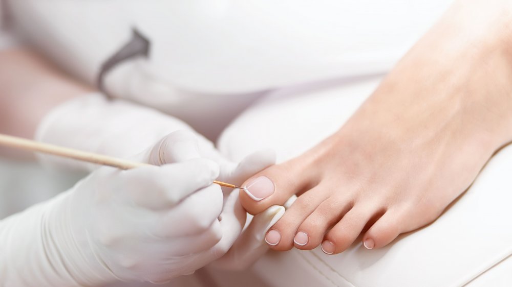 Woman painting her toenails