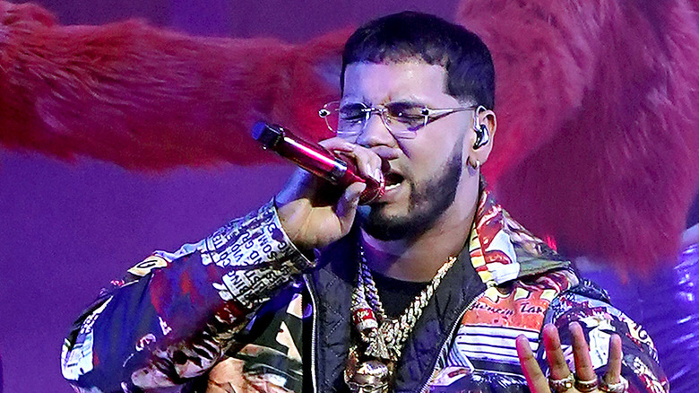 Singer Anuel AA singing at a concert