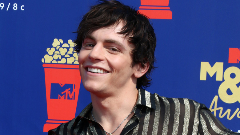 Ross Lynch smiling with dark hair.