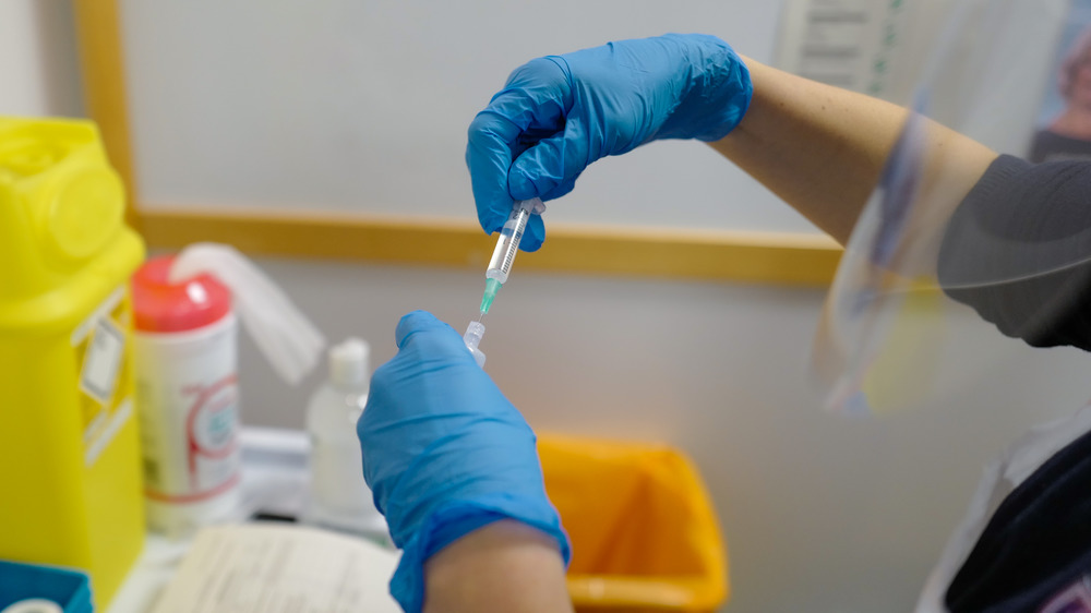 Health care worker with COVID-19 vaccine shot