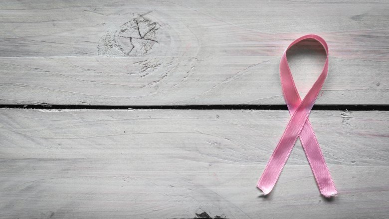 pink ribbon on wood background