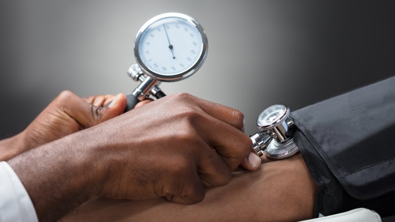 doctor's hands taking blood pressure