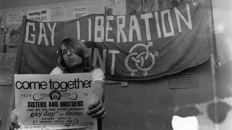 A Gay Liberation Front sign and member in 1971