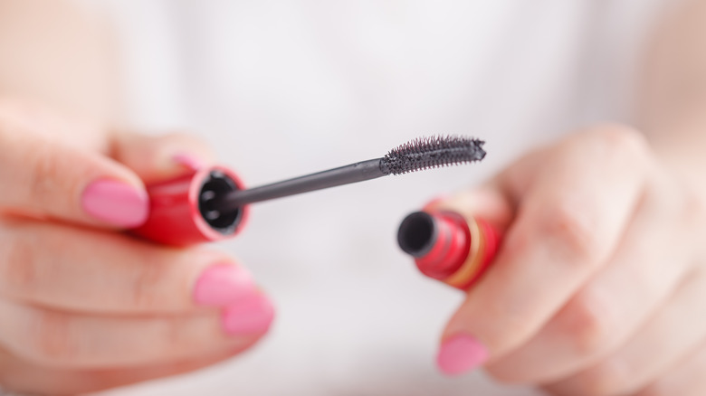 woman holding mascara