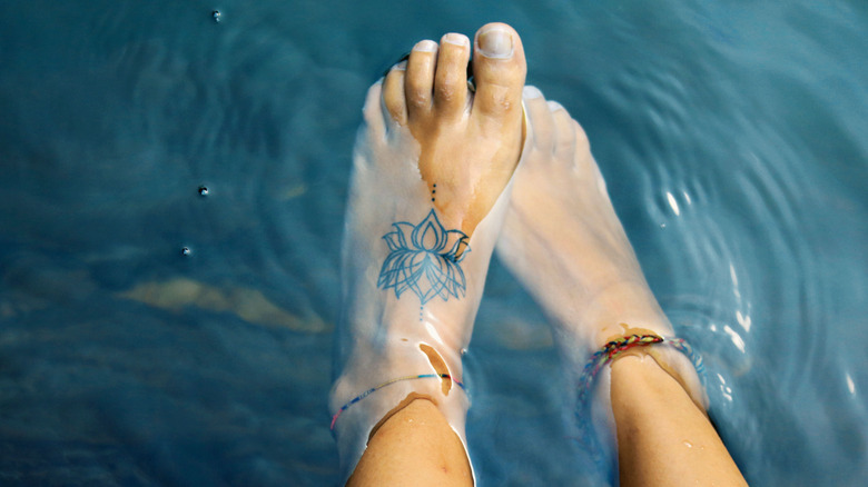 tattooed foot in water