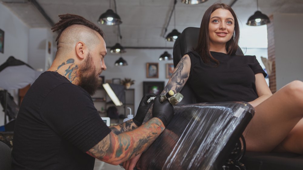 Woman getting tattoo