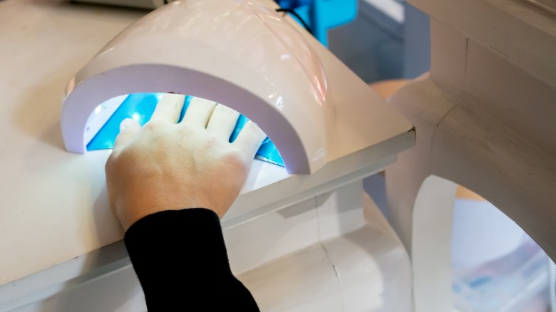 drying nails under UV lamp