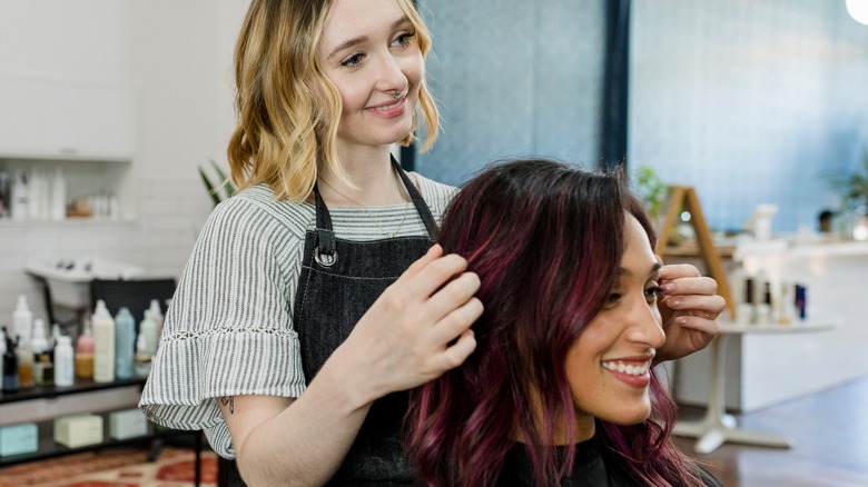 A female hairstylist and client