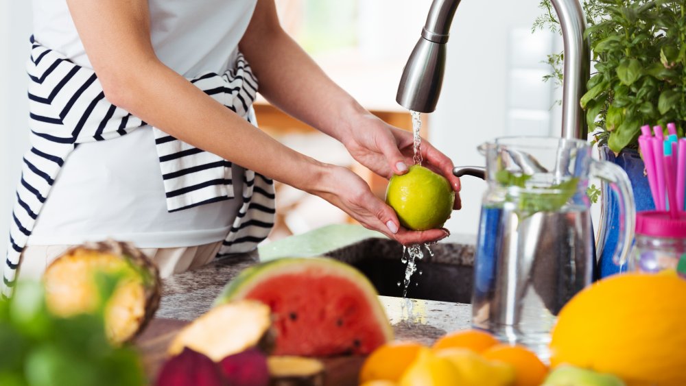 Woman washing fruit