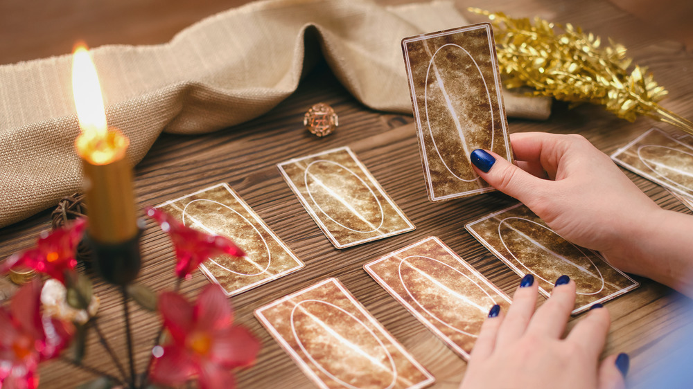 Hands holding tarot cards 