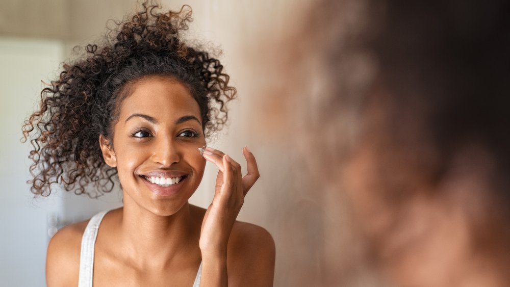 Woman applying skincare