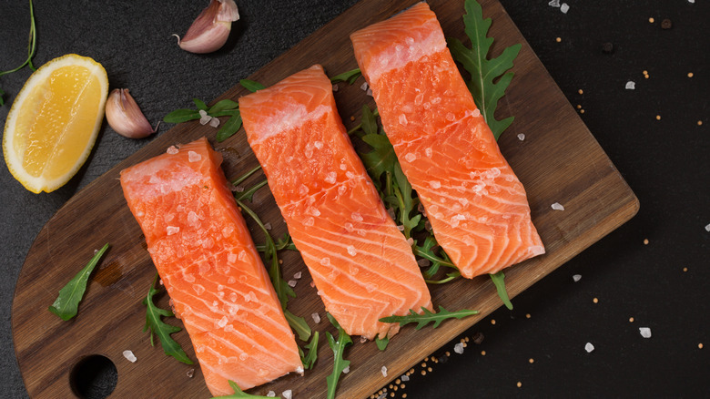 Pieces of fish on wooden board