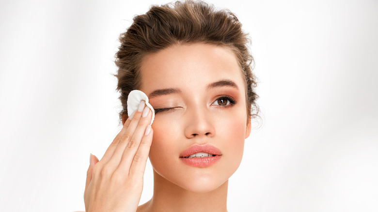 Woman removing eye makeup 