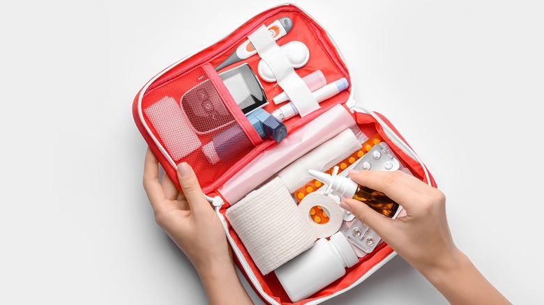 woman holds first aid kit 