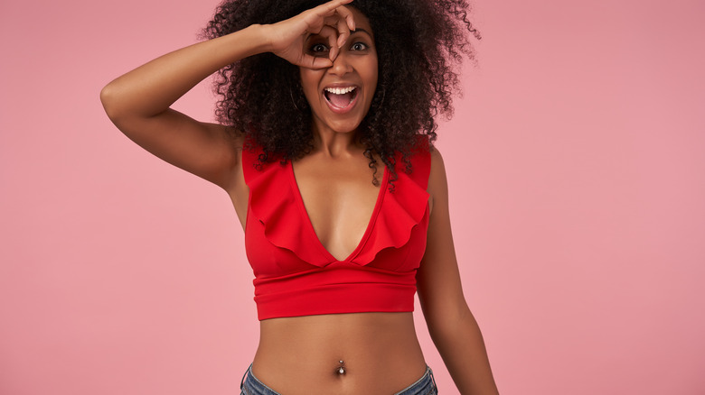 Red crop top and navel piercing