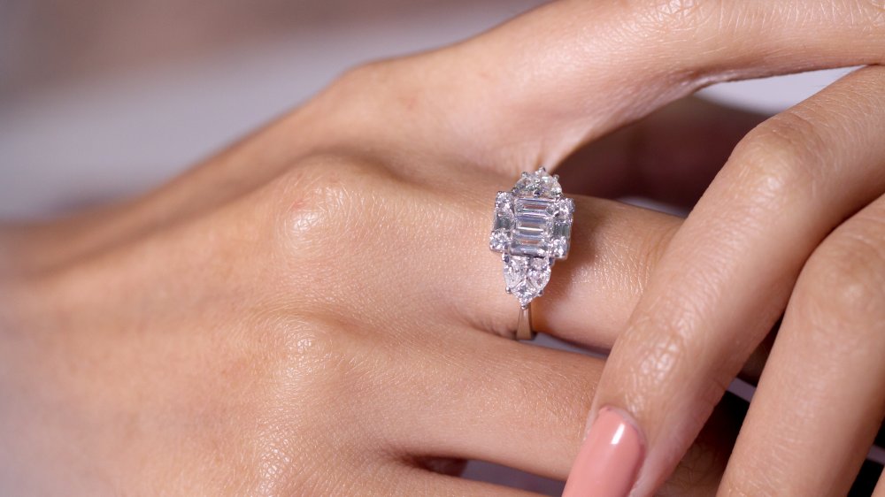 Emerald cut surrounded by smaller diamonds