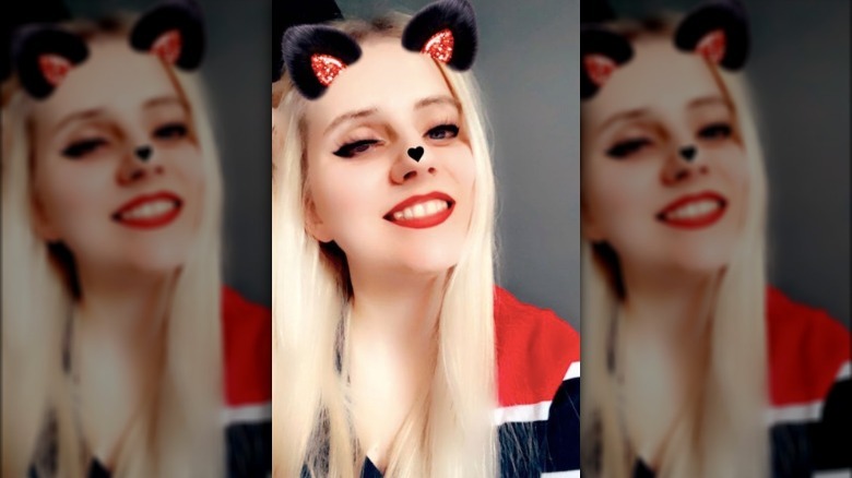 Woman takes a selfie with Snapchat filter