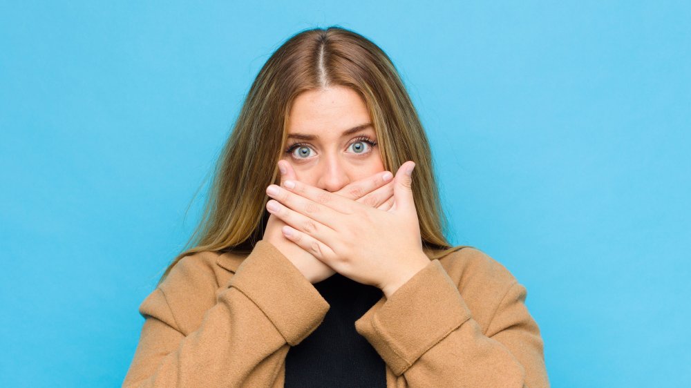 woman covering mouth and tongue