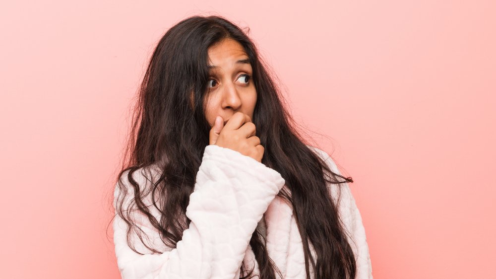 woman covering mouth