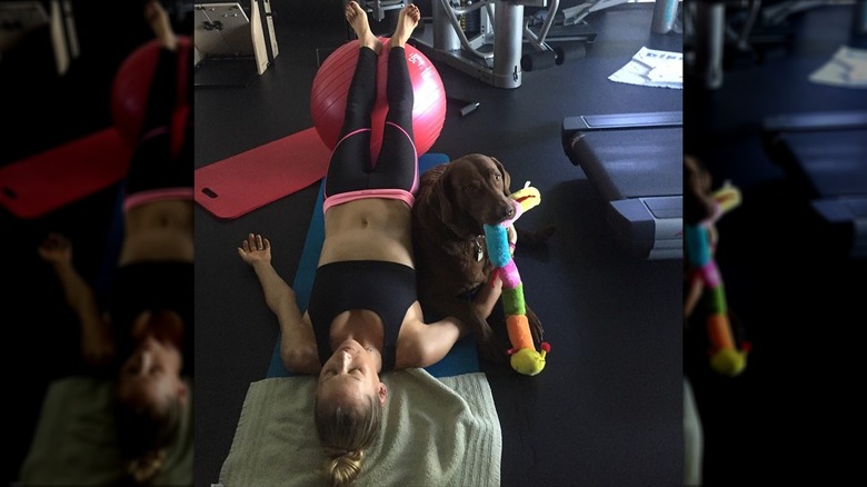 Anna Kournikova and dog in gym