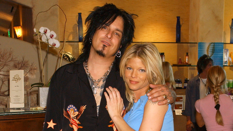 Nikki Sixx and Donna D'Errico posing in a restaurant